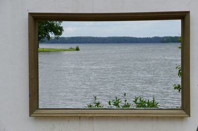Scenic view of lake seen through window