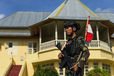 Portrait of a policeman standing in front of the building of the sultanate of ternate