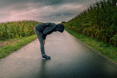 Rear view of person on road against sky