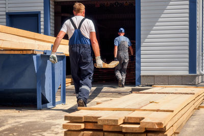 Full length of man standing on wood