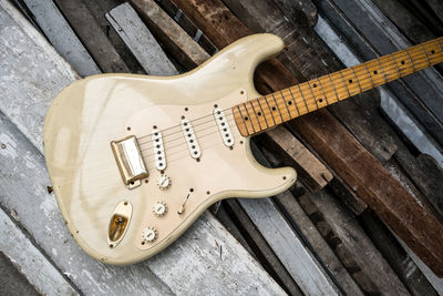 High angle view of electric guitar on wooden planks