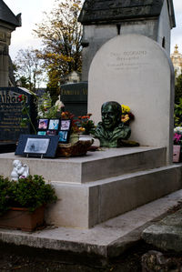 Statue in cemetery against built structure