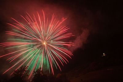 Low angle view of firework display at night