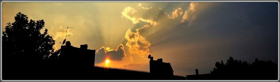 Silhouette of built structure at sunset