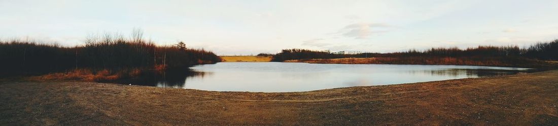 Scenic view of lake against sky during sunset