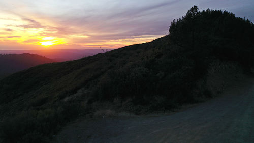 Scenic view of silhouette mountains against sky during sunset