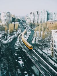 High angle view of train on bridge in city during winter