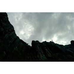 Scenic view of mountains against cloudy sky