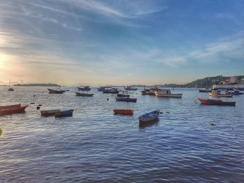 Boats moored on sea against sky