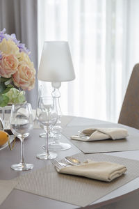 Close-up of white flowers on dining table.