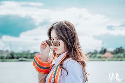 Portrait of young woman standing outdoors