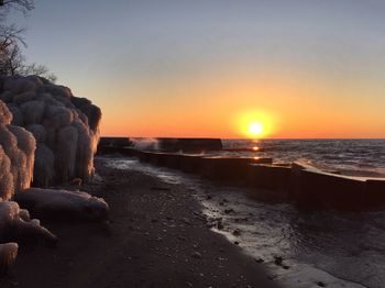 Scenic view of sea against clear sky during sunset