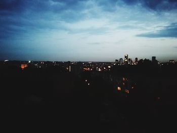 Silhouette buildings against sky at night