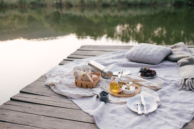 High angle view of food on pier over lake