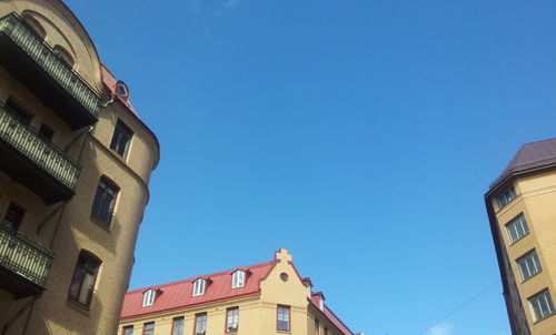 Low angle view of historic building against blue sky