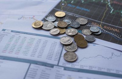 High angle view of coins on paper