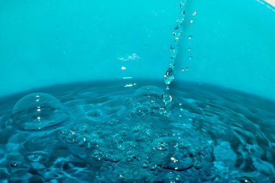 Close-up of water drops on blue sea