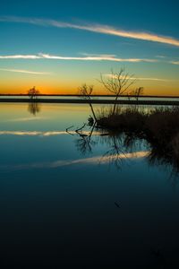 Scenic view of lake against sky during sunset