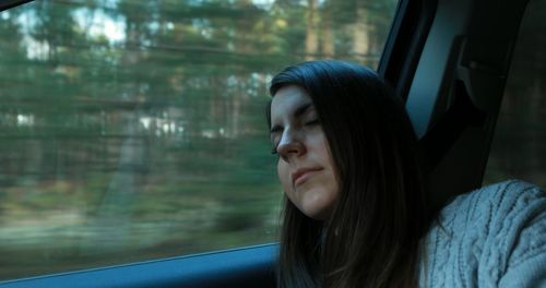 Portrait of woman looking through window