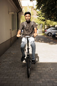 Portrait of man riding bicycle on street