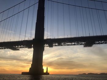 Low angle view of silhouette bridge against sky during sunset