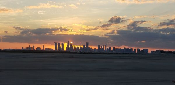 Modern buildings in city during sunset