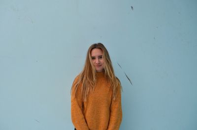 Young woman standing against white background