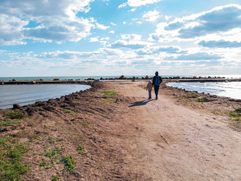 Full length of man on beach against sky