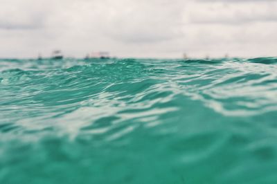 Rippled water against clouds