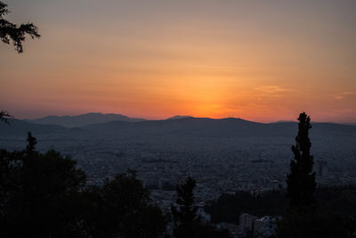 Silhouette tree on mountain against sky during sunset