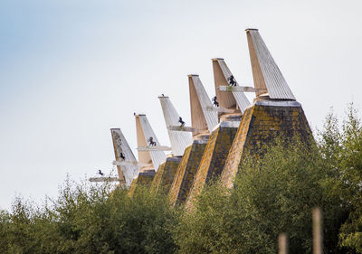 Low angle view of roof and buildings against sky