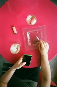 High angle view of woman holding drink