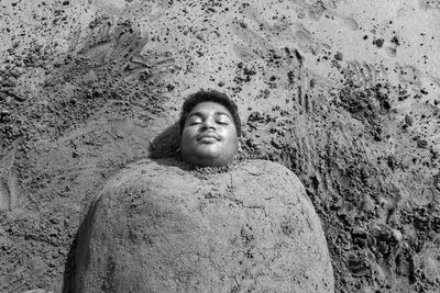 Portrait of young man standing on rock