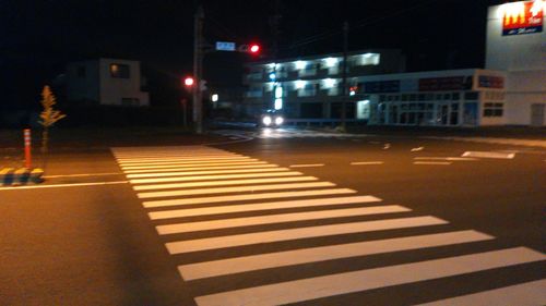 Zebra crossing on road at night