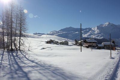 Scenic view of snowcapped mountains against clear blue sky