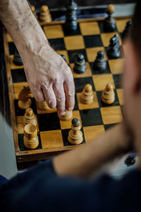 Low angle view of man playing on chess board