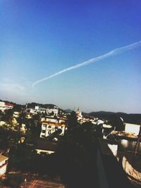Aerial view of cityscape against clear blue sky