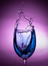 Close-up of water drops on glass against white background