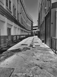 Surface level of empty road along buildings