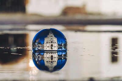 Close-up of water floating on river against sky