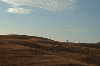 Scenic view of arid landscape against sky