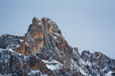 Low angle view of snowcapped mountains against clear sky