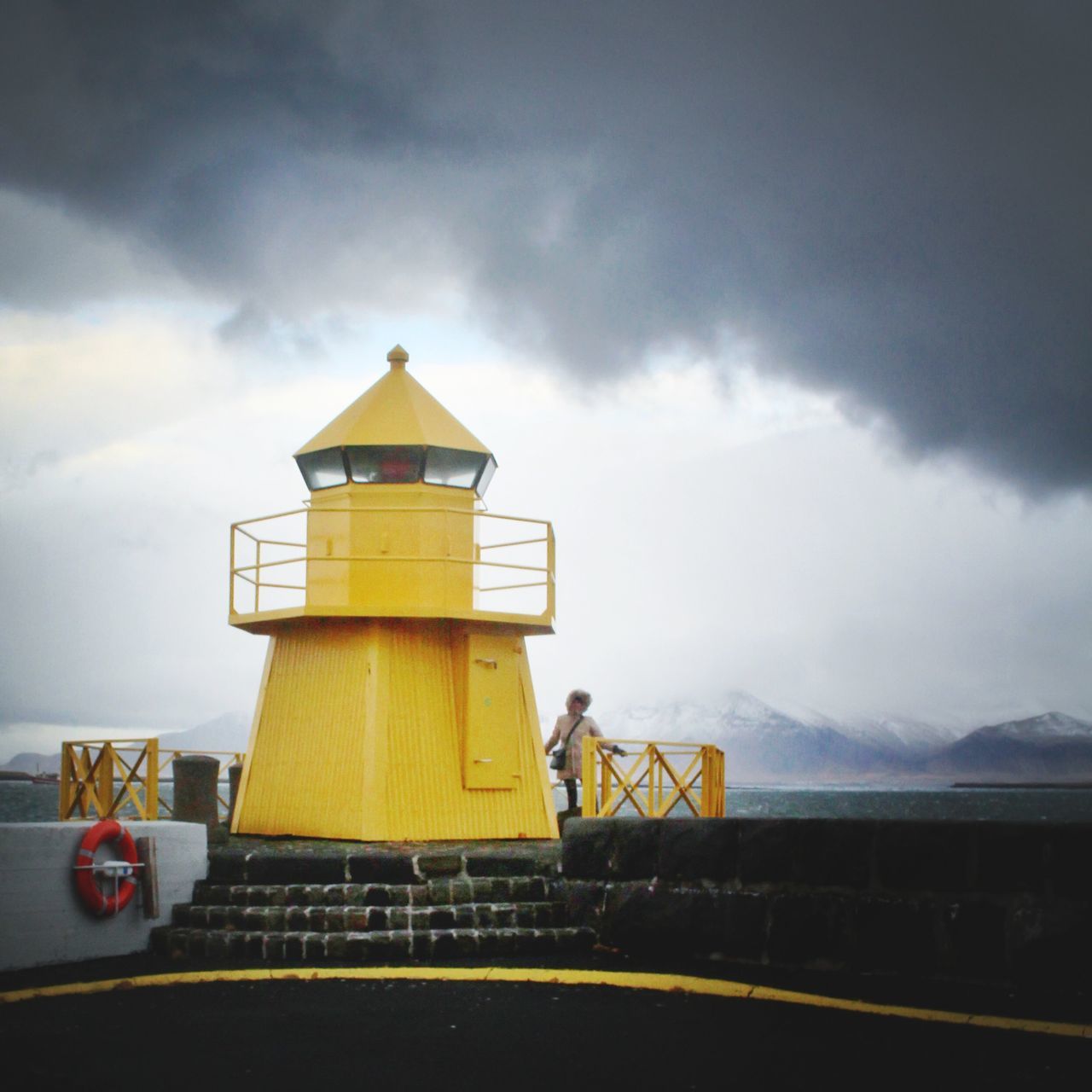 sky, cloud - sky, building exterior, built structure, cloudy, architecture, yellow, cloud, weather, safety, protection, guidance, railing, security, lighthouse, nature, outdoors, sunset, overcast, sea