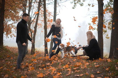 People walking on leaves in forest