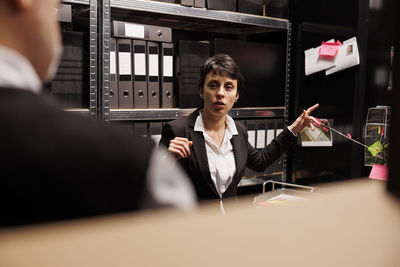 Portrait of businesswoman using mobile phone in office