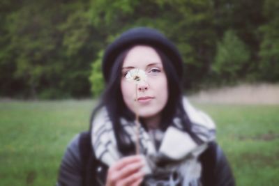 Portrait of beautiful young woman in field