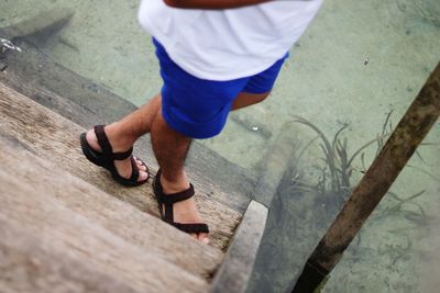 Low section of man standing on floor