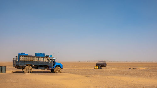 Sudan, february 10., 2019, water wagons and water barrels in the the desert of sudan