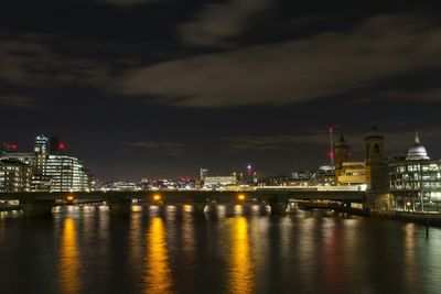 River with illuminated structures in distance