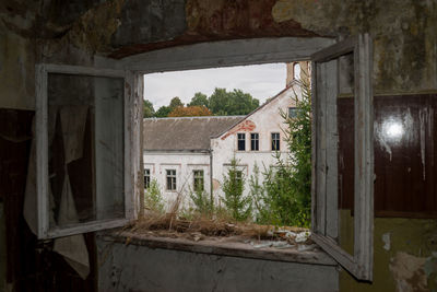 Abandoned building seen through window